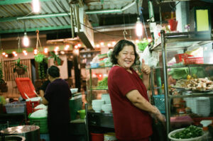 woman in Vietnam cooking pho at a local night market